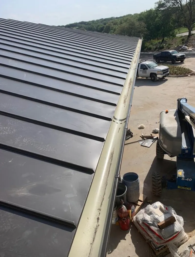 Standing seam panel and gutter detail on a metal roofing jobsite in Gun Plain